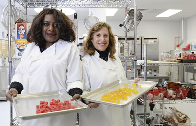 DENVER, CO - DECEMBER 29:  Owners Deloise Vaden, left, and Elyse Gordon in the kitchen of their  business Better Baked, where they produce marijuana edibles in Denver on Tuesday, December 29, 2015.  The business makes edibles for medical and recreational marijuana use.  They were holding colorful crystal dice edibles for recreation use. (Photo by Cyrus McCrimmon/The Denver Post)